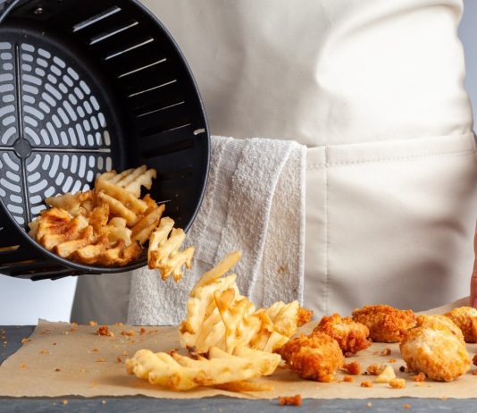A,Woman,Is,Dumping,Fresh,Made,Potato,Waffle,Fries,From